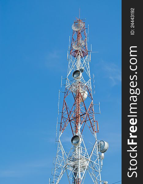 High tower with antenna for communication over blue sky. High tower with antenna for communication over blue sky