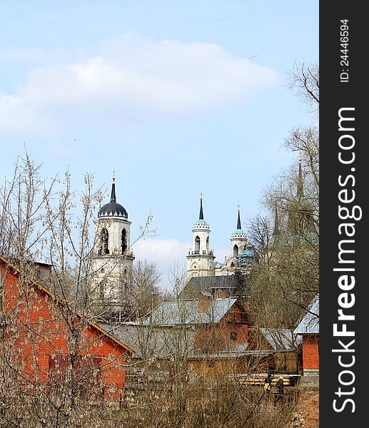 Russian village in the early spring. In the background there is the church of the eighteenth century. Russian village in the early spring. In the background there is the church of the eighteenth century