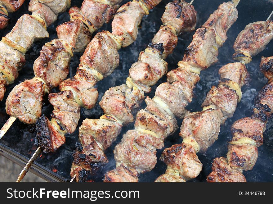 Tasty grilled meat on skewers closeup