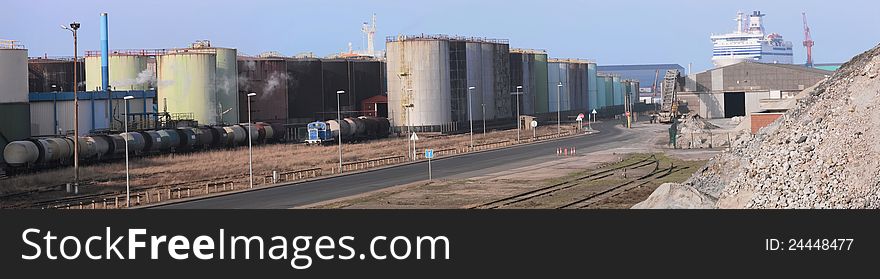 Panoramic view of chemical tanks, minerals, and railway in an harbour by a sunny day. Panoramic view of chemical tanks, minerals, and railway in an harbour by a sunny day
