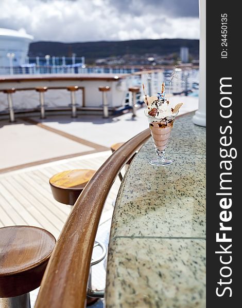 Cup of ice cream in an outdoor cafe on open deck of cruise ship