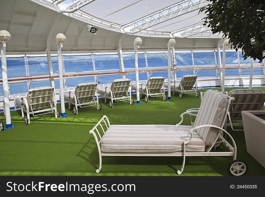 Sunbeds on open deck of the cruise ship on sunny day. Sunbeds on open deck of the cruise ship on sunny day