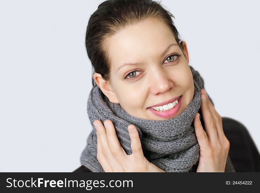 Young woman holding hands on a muffler, because she got a cold, with reddened eyes and nose. Young woman holding hands on a muffler, because she got a cold, with reddened eyes and nose