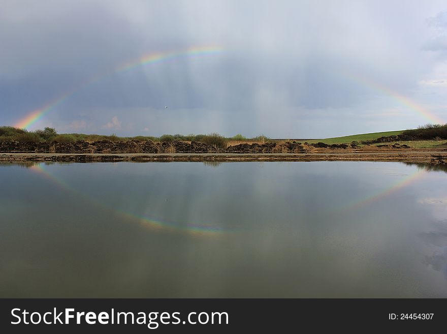 Rainbow over a fishing lake. Rainbow over a fishing lake