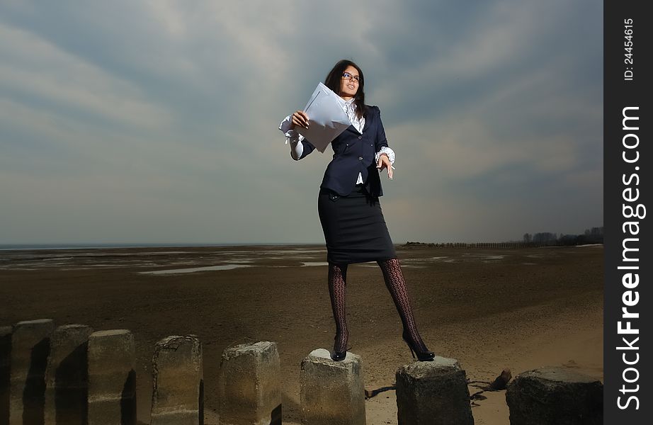 Business Lady Standing On The Beach, On A Backgrou