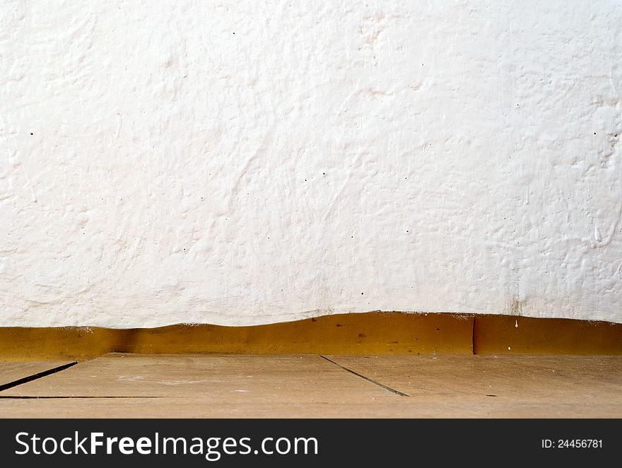 Vintage interior of painted stone wall and wooden floor. Vintage interior of painted stone wall and wooden floor