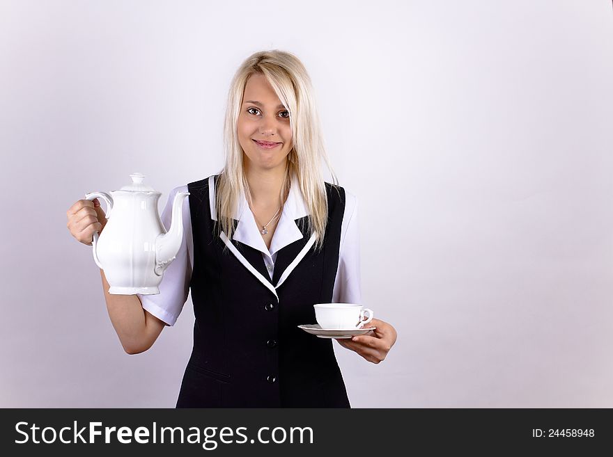 Smiling beautiful blonde girl with a white cup and pot. Smiling beautiful blonde girl with a white cup and pot