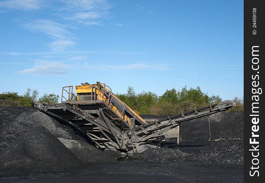 Crusher plant in a slate mine under a clear blue sky. Crusher plant in a slate mine under a clear blue sky.