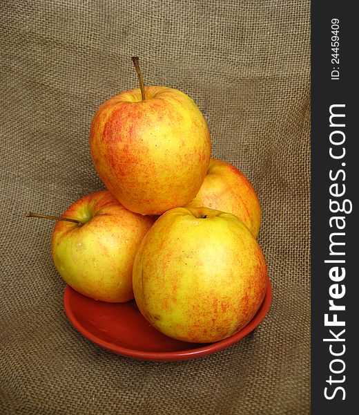 Nice apples on the plate isolated on the white background