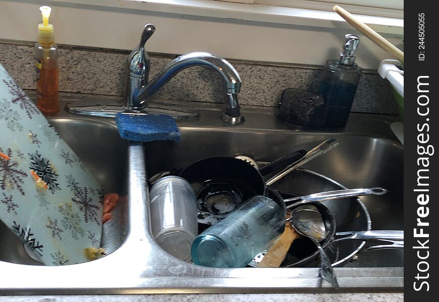 DIRTY SINK FULL OF DISHES