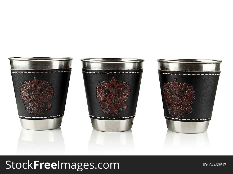 Three metal cups for drinking on a white background. Three metal cups for drinking on a white background.