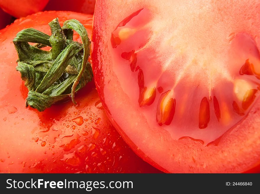 Cut and whole tomato closeup. Cut and whole tomato closeup