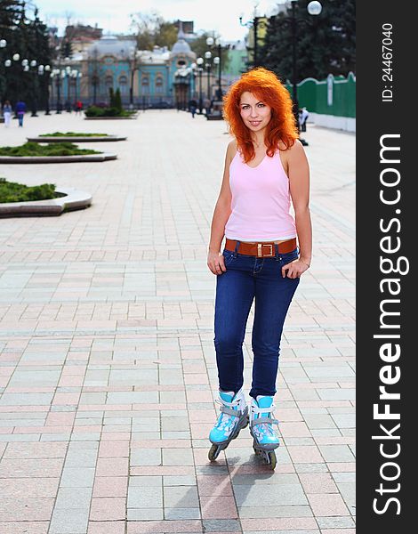 Ginger girl on roller skates in Mariinsky Park in Kiev