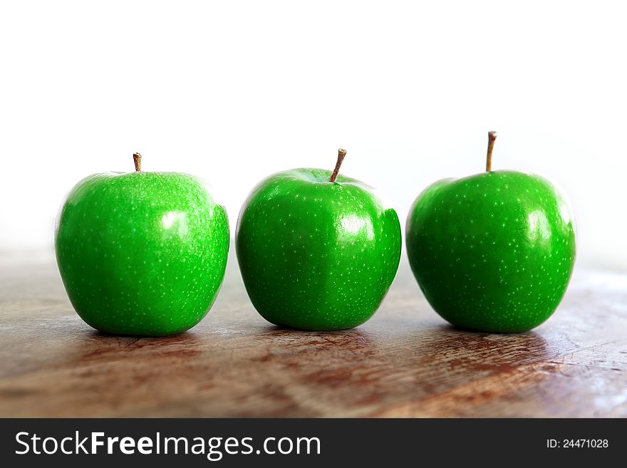 Fresh green apples on a wooden table. Fresh green apples on a wooden table.