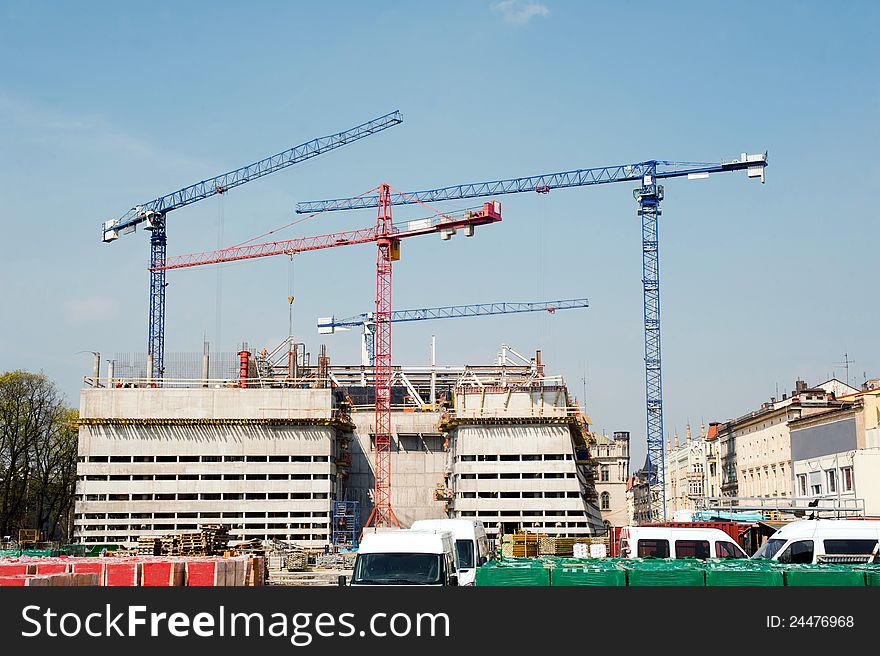 Construction cranes at big construction site in a city