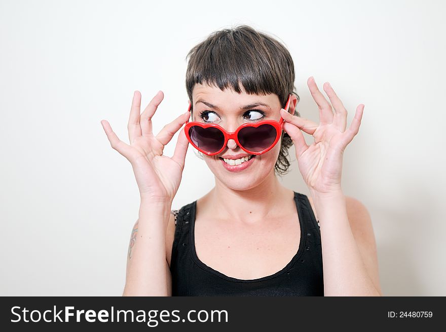 Funny woman with red heart sunglasses