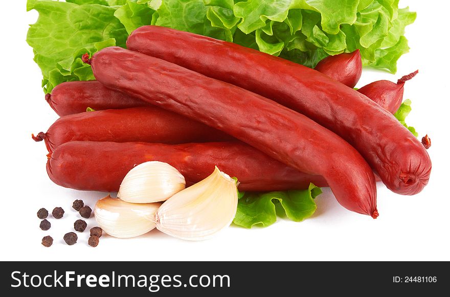Sausage arranged with lettuce on white background