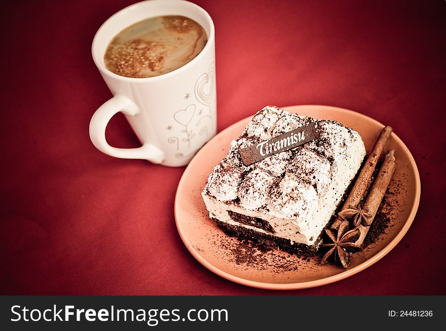 Classic tiramisu with stick of cinnamon and stars of anise on a plate. Classic tiramisu with stick of cinnamon and stars of anise on a plate