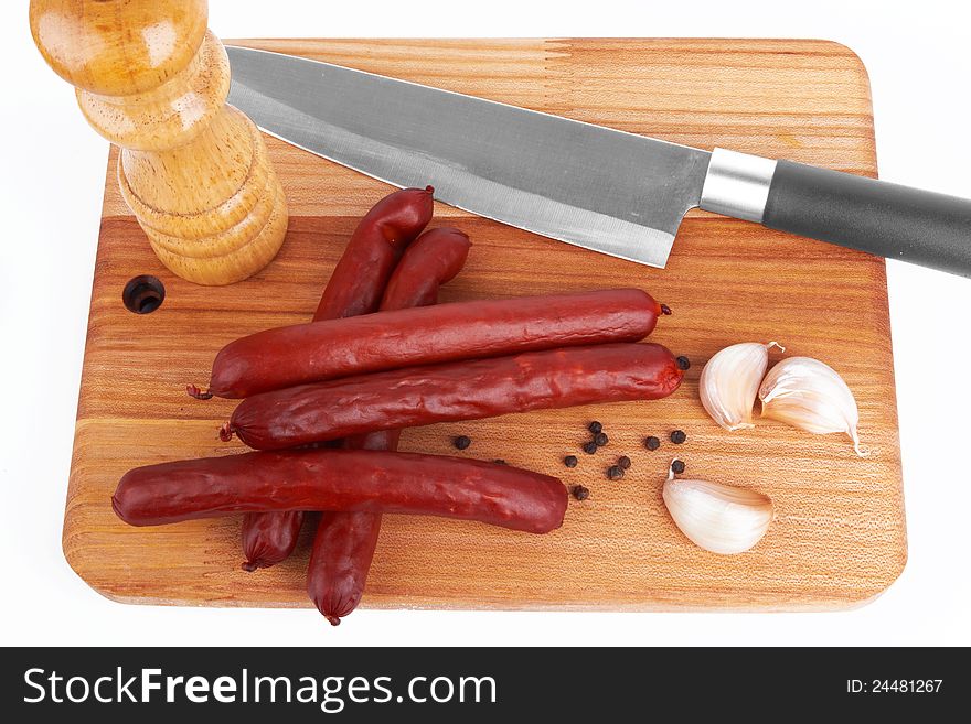 Sausage on board on white background