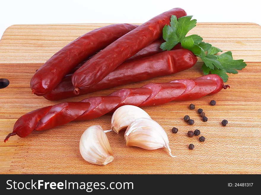 Sausage on board on white background