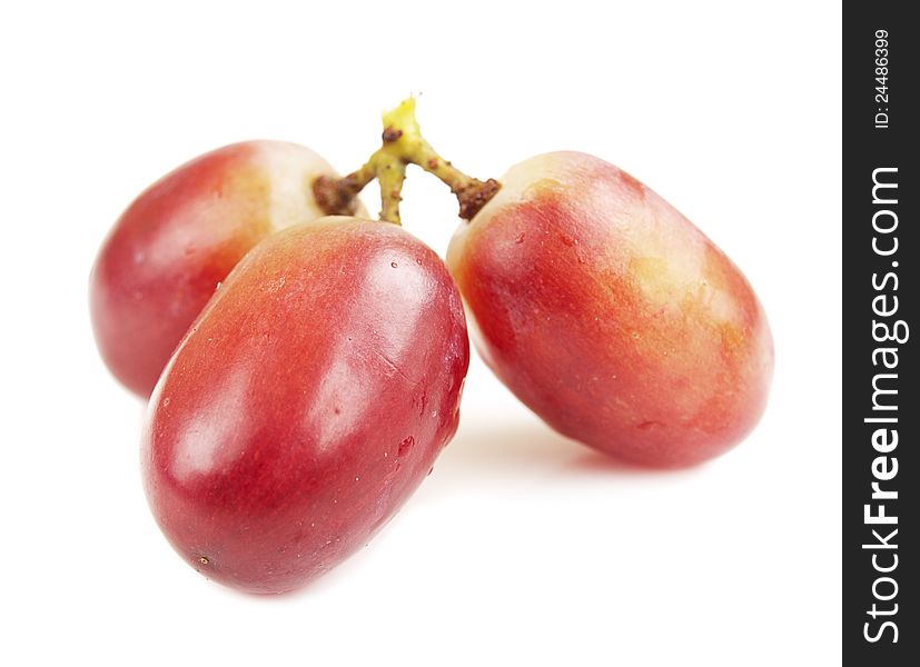 Red seedless grapes on a white background. Red seedless grapes on a white background