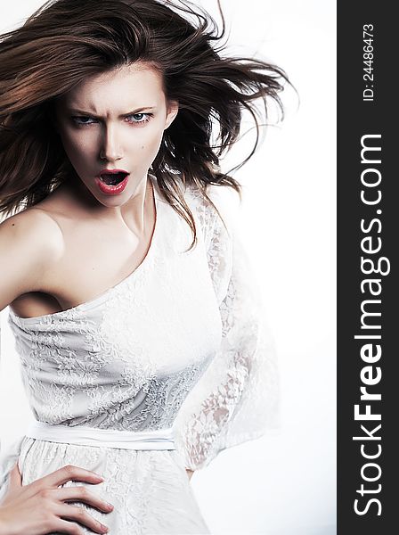 Young angry woman brunette with waving hair screaming Studio shot. Young angry woman brunette with waving hair screaming Studio shot