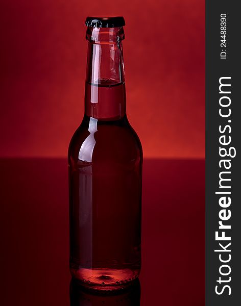 Glass bottle on a red background