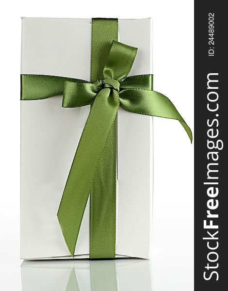 White cardboard box with a green ribbon. White cardboard box with a green ribbon.