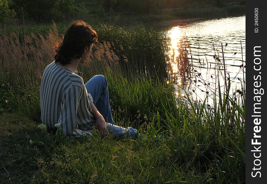 Man watching the lake in a beautiful sunset. Man watching the lake in a beautiful sunset