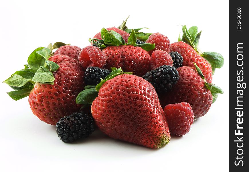 Strawberries, raspberries, and blackberries on white