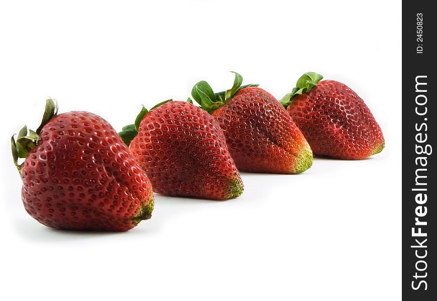 Four strawberries shot on a white background