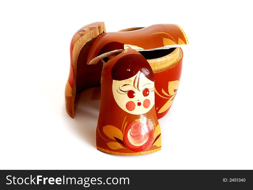 Pieces of broken nesting doll lying on a white background