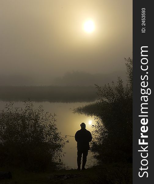 Morning on the foggy river. The person fishes. The river in Belarus. Morning on the foggy river. The person fishes. The river in Belarus