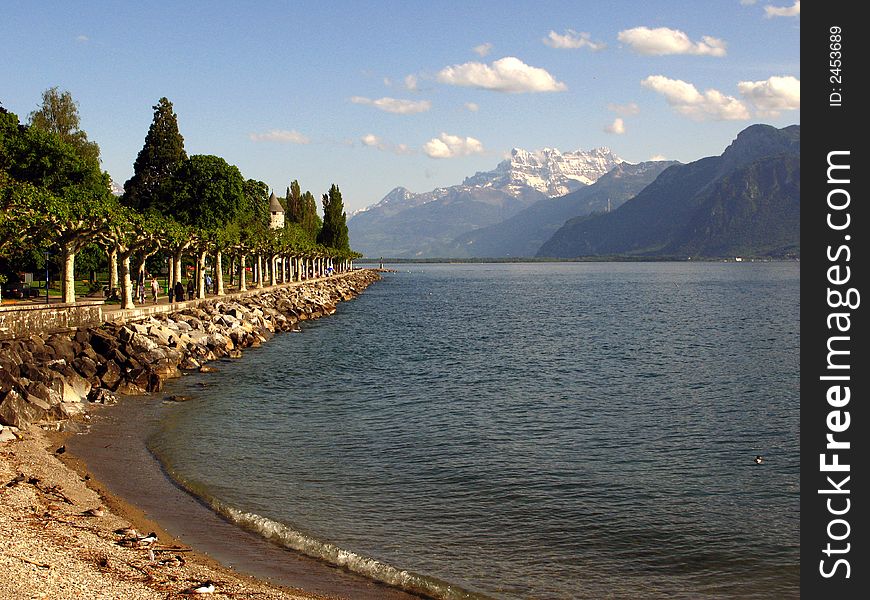 A small beach on the Lake Geneva (Leman) in Vevey with a view towards the Dents du Midi, a spectacular mountain range in the Swiss Alps. A small beach on the Lake Geneva (Leman) in Vevey with a view towards the Dents du Midi, a spectacular mountain range in the Swiss Alps.