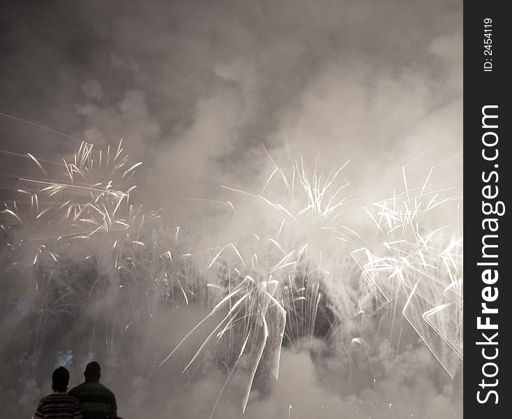 A couple watch a fireworks display