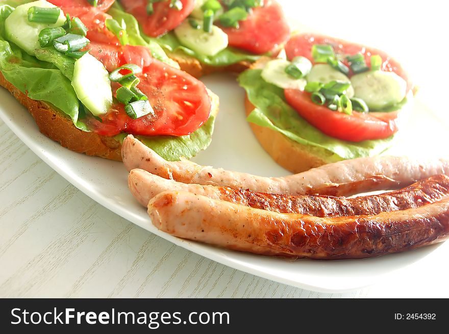 Plate with sandwiches and sausages