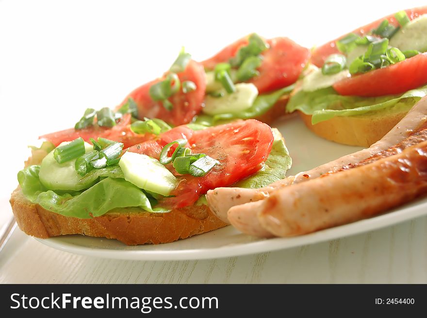 Plate with sandwiches and sausages