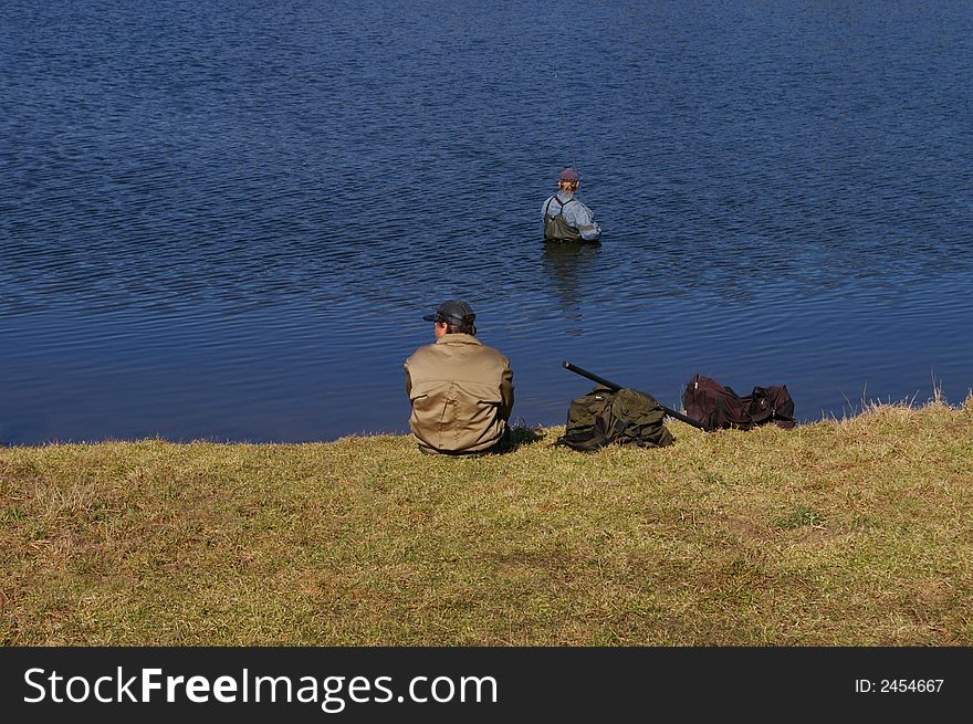 Two fishermen on lake in the early spring. Two fishermen on lake in the early spring