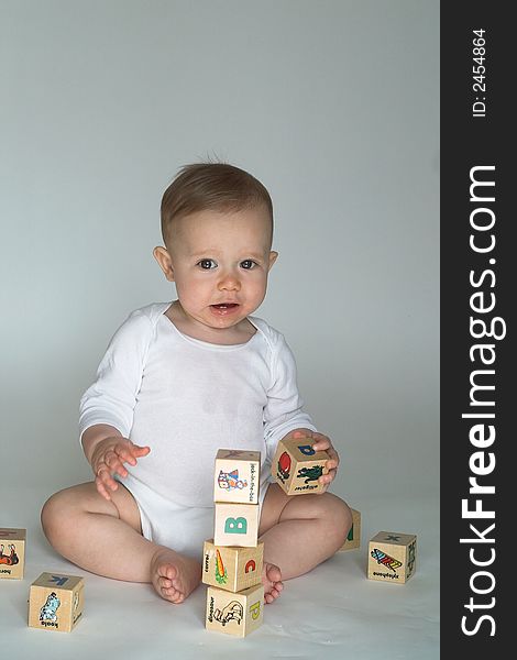 Image of cute baby playing with alphabet blocks. Image of cute baby playing with alphabet blocks