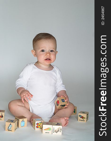 Image of cute baby playing with alphabet blocks. Image of cute baby playing with alphabet blocks