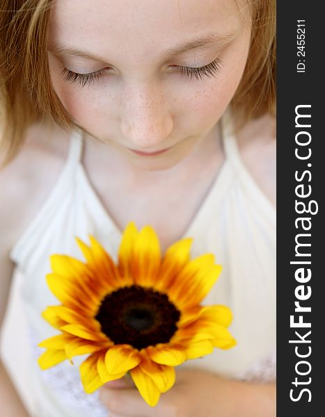 Soft portrait of girl with Sunflower in the hands