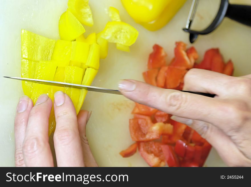 Yellow and red bell peppers become cutted. Yellow and red bell peppers become cutted