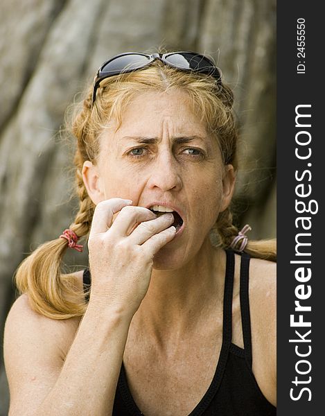 A woman eating a snack outside