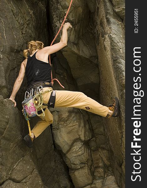 A woman climbing a sea cliff in Okinawa Japan. A woman climbing a sea cliff in Okinawa Japan