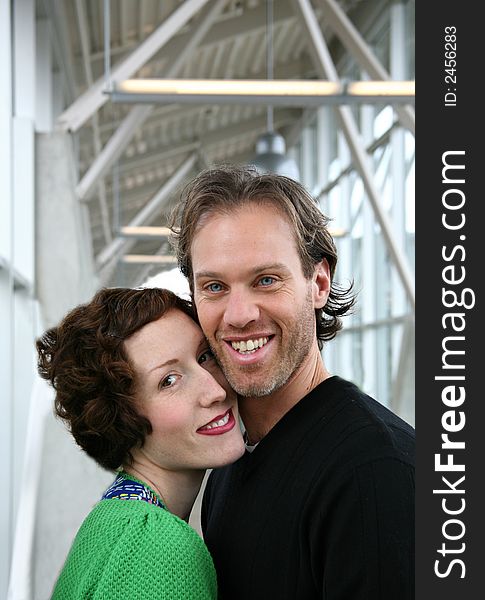 Image of a young and attractive couple in love...shot in a modern building setting. Image of a young and attractive couple in love...shot in a modern building setting