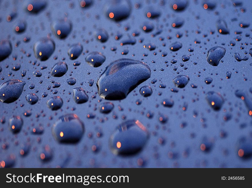 Water droplets and light on the car surface