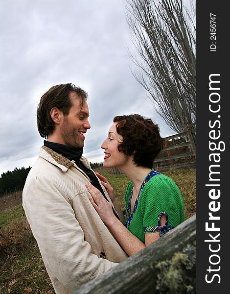 Image of a young loving couple in a rural setting. Image of a young loving couple in a rural setting.