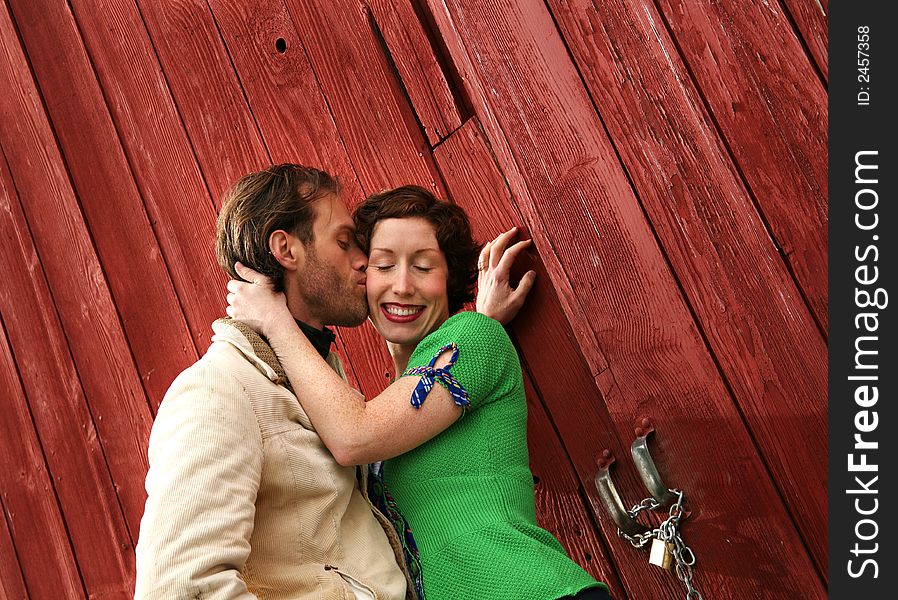 A sweet moment between a loving couple....against a rustic red barn. A sweet moment between a loving couple....against a rustic red barn