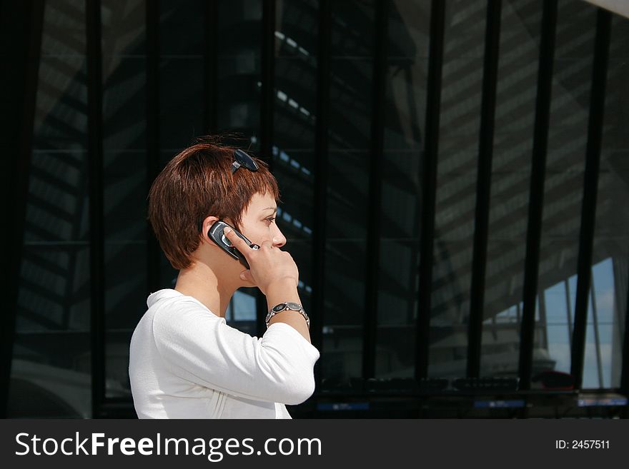 Portrait of an active woman discussing with her telephone. Portrait of an active woman discussing with her telephone