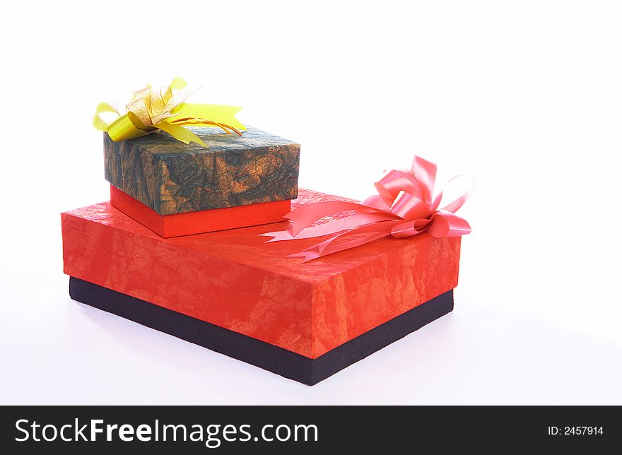 View of two boxes with presents on white sheet